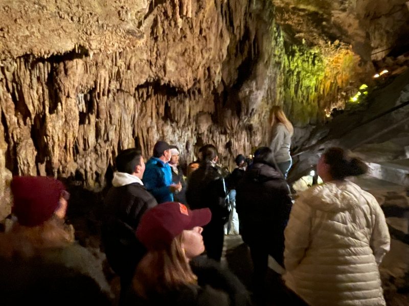 Students walking through a cave